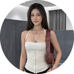 Portrait of Maya Cheng wearing a modern halter cutout crop top against a minimalist charcoal and slate gray background.