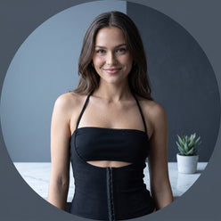 Ingrid Holm wearing a halter cutout crop top in a professional circular portrait with a clean, neutral background.