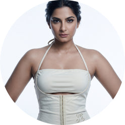 A circular portrait of Rhea Kapoor wearing a halter cutout crop top against a clean, bright white background.